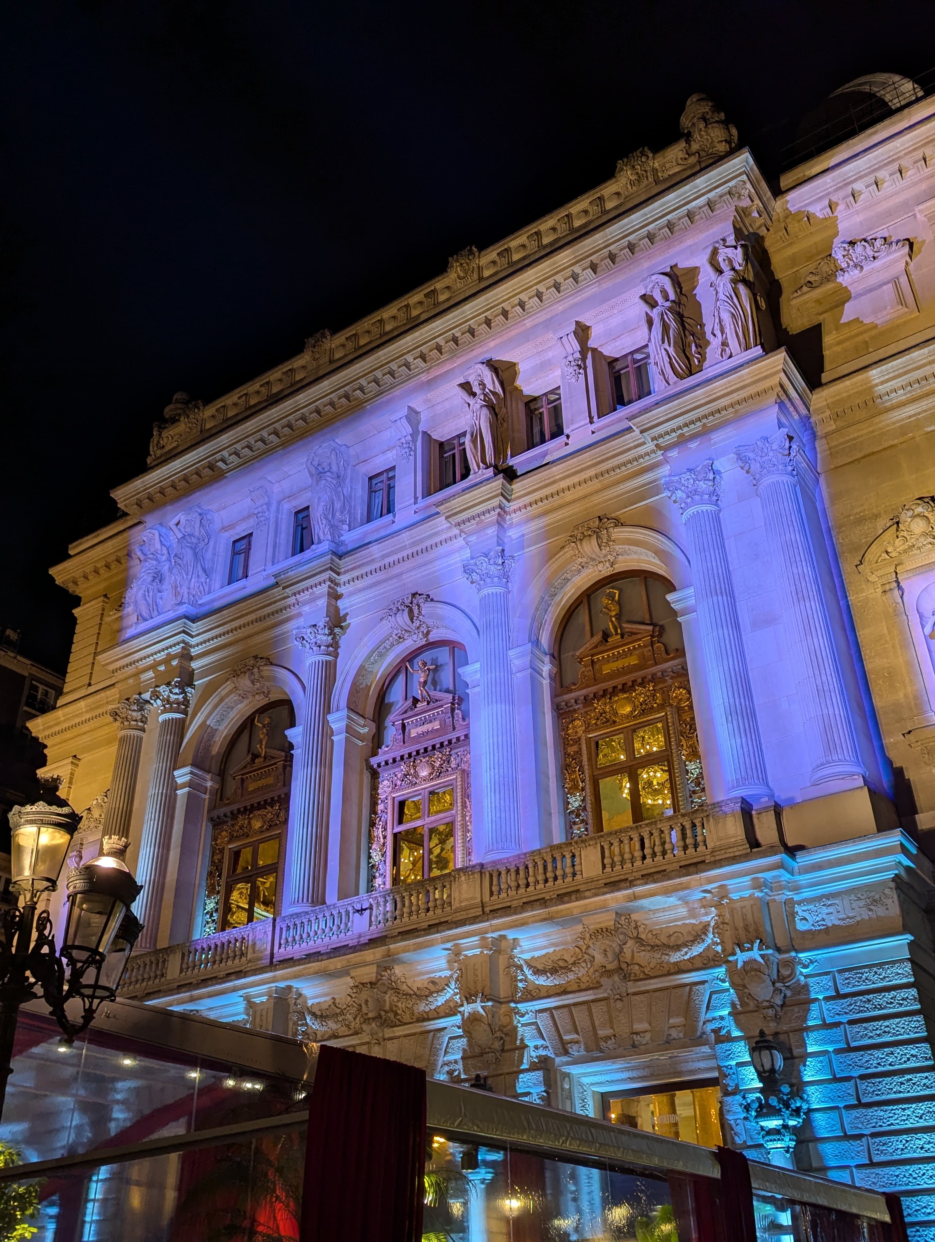 La façade illuminée de l'Opéra Comique et ses cariatides, de nuit